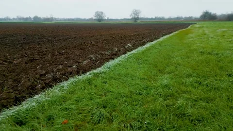 Fast flight over a plowed field in winter Stock Footage 228651825