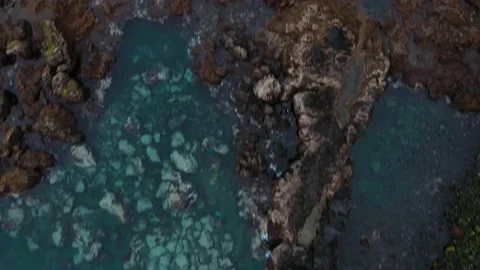 Fast flight over the surface of the water and stones visible from it.. Rocky Stock Footage 152837777
