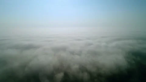 Fast flight over white thick clouds. The horizon divides the blue sky. Video stock 211760000