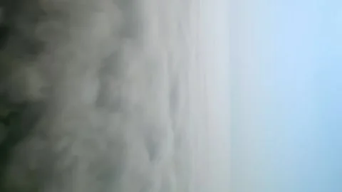 Fast flight over white thick clouds. The horizon divides the blue sky. Video stock 212155110