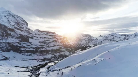 Fast flight over winter landscape with snowy mountains at sunset Stock Footage 83287969