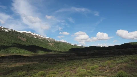 Fast floating clouds over the mountains and the forest. Stock Footage 76934185