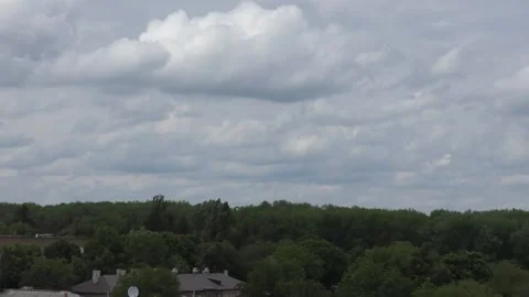 Fast-floating gray rain clouds over a green forest.  Time lapse video Stock-Footage 131440471
