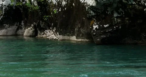 Fast flow of a mountain river with emerald water among the rocky banks Stock Footage 247509333