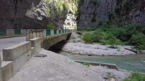 Fast flow of mountain river under the old auto bridge in Abkhazia Stock Footage 101068510