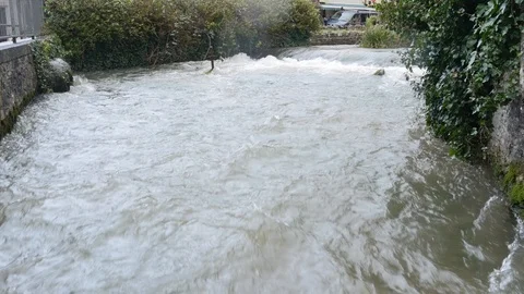 A fast flowing flooded stream Stock Footage 126714466