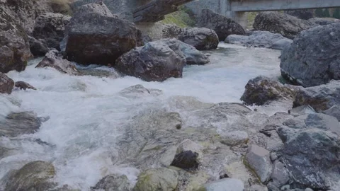 Fast flowing mountain river rushing across huge rocks 스톡 동영상 330440278