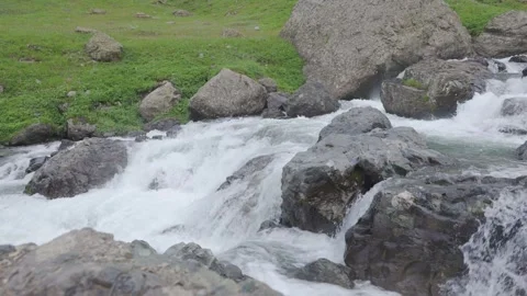 Fast flowing mountain stream cascading over grey rocks Stock Footage 342463401
