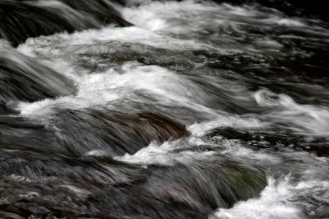Fast flowing mountain stream Stock Photos