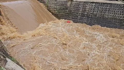 Fast Flowing Muddy River After Heavy Rain in Tulungagung Stock Footage 332646434