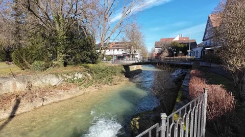 Fast-Flowing Narrow River in Bad Überkingen with Half-Timbered Houses and a Brid Stock Footage 302847828
