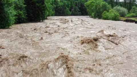Fast flowing raging river after strong rain. Aerial flight above dirty mountain Stock Footage 152419168