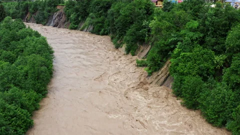 Fast flowing raging river after strong rain. Aerial flight above dirty mountain Stock Footage 152419671