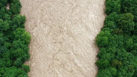 Fast flowing raging river after strong rain. Aerial flight above dirty mountain Stock Footage 152419988