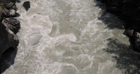 Fast flowing raging river. Soil and mud is moving towards down Stock Footage 260112128