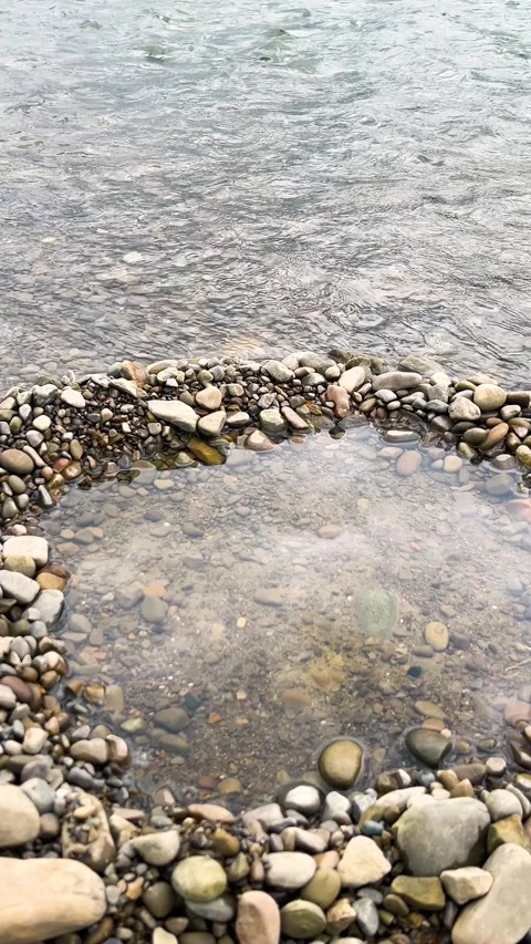 A fast flowing river with clear rippling water.  Stockbeeldmateriaal 339092020
