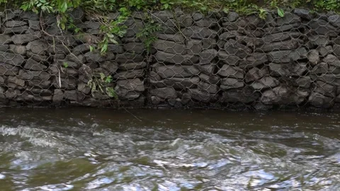 A fast-flowing river enclosed by a steep bank Stock Footage 137270009