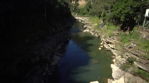A fast-flowing river flows between two mountains in Mizoram Видео 333483489