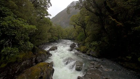 Fast flowing river handheld slow motion shot panning down a Video stock 93781557