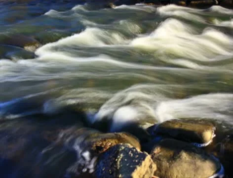 Fast flowing river rapids - 2K Video stock 10573913