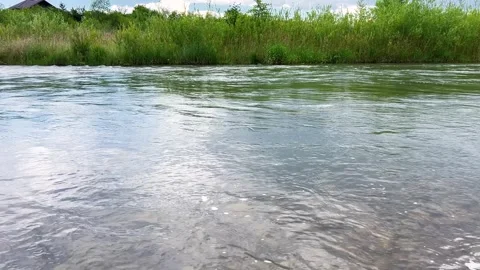 Fast-flowing river with ripples on the surface moves. Stock-Footage 339090135