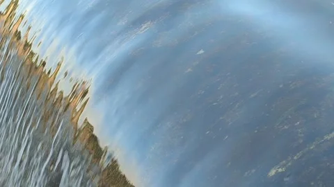 Fast-Flowing River Water Cascading Over a Small Weir Stock Footage 341536580
