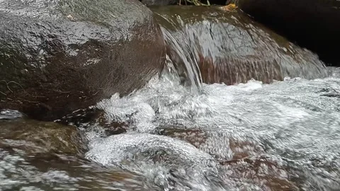 Fast Flowing River Water Over Rocks in Nature Stock Footage 330519282