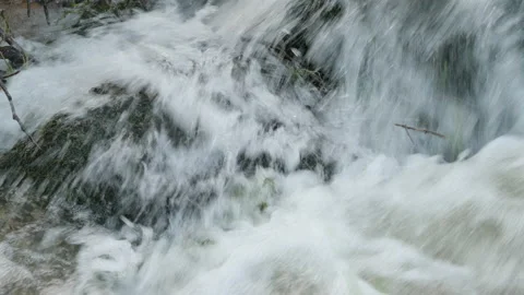 Fast flowing river water splashes and crashes over rocks. 4K locked tripod Stock Footage 145605685
