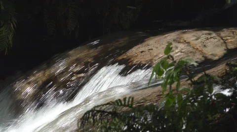 Fast flowing stream water passes over smooth rock Stock Footage 46776633