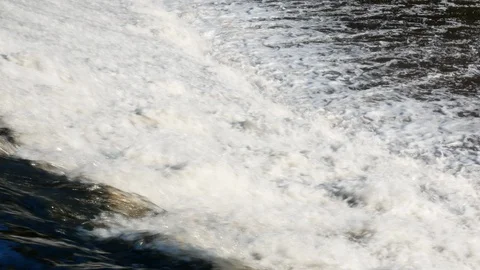 Fast flowing water over dam on Ave river in Vila do Conde, Portugal with ruin Stock Footage 112765136