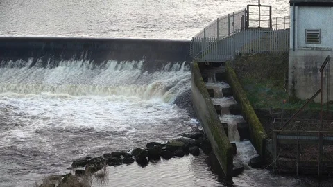 Fast flowing water of a river, down a fish ladder. Stock Footage 98826278