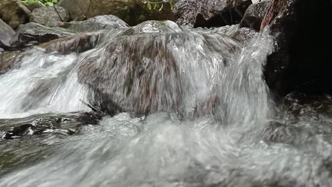 Fast Flowing Water Stream Over Rocks Close-Up Texture Shot Stock Footage 330538566