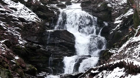 Fast Flowing Water in a Waterfall During Winter Stock Footage 61016949