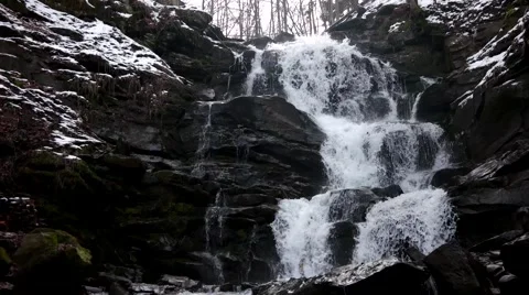 Fast Flowing Water in a Waterfall During Winter Stock Footage 61017717
