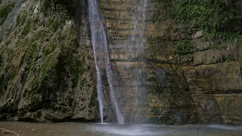 Fast flowing waterfall cascading over a cliff Stock Footage 124029834