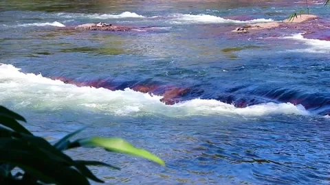 Fast flowing waterfall stream cascading powerfully through natural rocks Stock Footage 326776155