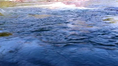 Fast flowing waterfall stream cascading powerfully through natural rocks Stock Footage 326776156