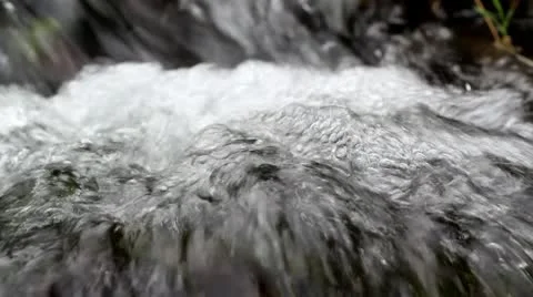 Fast flowing Welsh stream with bubbles Stock Footage 10716409