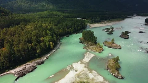 A fast-flowing wide and full-flowing mountain river. Large rocks stick out of Stock Footage 166472231