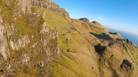 Fast fly by of rock formations alongside mountain. FPV drone drone aerial 4K Stock Footage 104578133
