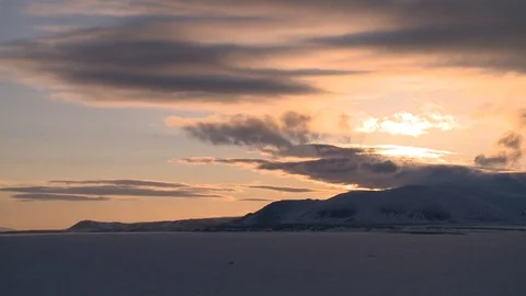 Fast flying beautiful clouds over the snowy mountains. Stockbeeldmateriaal 122804610