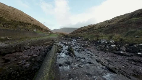 Fast Flying Fpv Drone View Rocky River Flow In Ireland surrounded by mountain 스톡 동영상 262974423