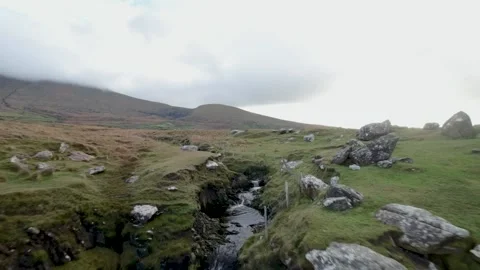 Fast Flying Fpv Drone View Rocky River Flow In Ireland surrounded by mountain Video stock 262974432