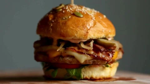 Fast food, Beef burger rotating 360 loop on the black plate on black background Stock Footage 336578509