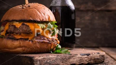 Fast Food With Burger Or Cheeseburger, And Soft Drink On Vintage Wooden Table