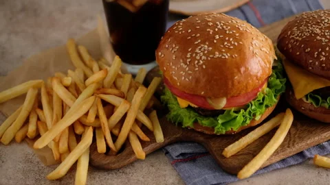 Fast food. Macro, top view of burgers, french fries, cola. A woman made a Stock Footage 137611161