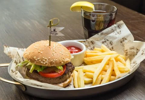 Fast food menu with hamburger and glass of cola Stock Photos