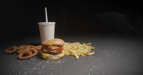 Fast food menu tracking shot in studio. Hamburger with french fries, onion rings Stock Footage 144798778