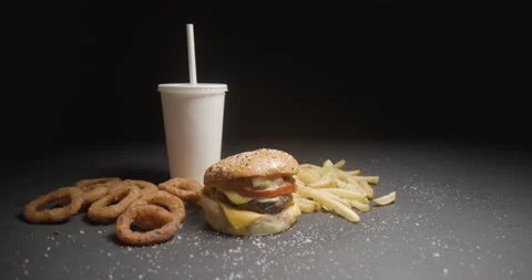 Fast food menu tracking shot in studio. Hamburger with french fries, onion rings Stock Footage 144799166