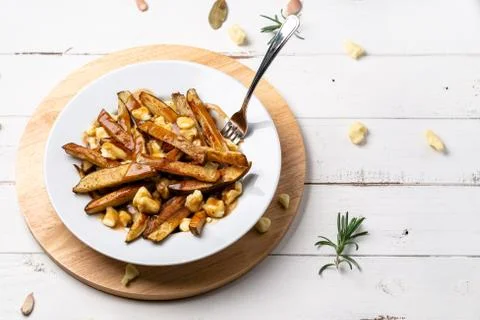 Fast food poutine with fork dug in. Stock Photos